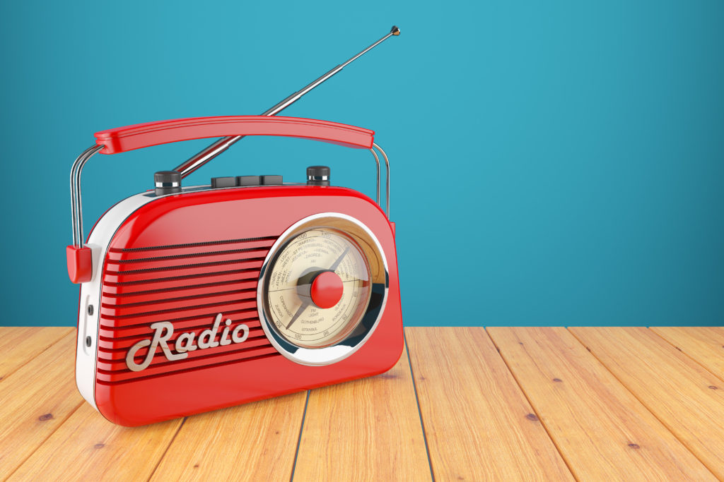 Vintage red radio receiver on wood table
